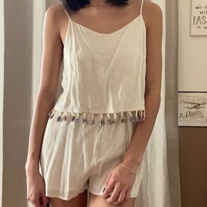 cream romper with rainbow tassels